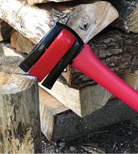 Wood splitting axe in log