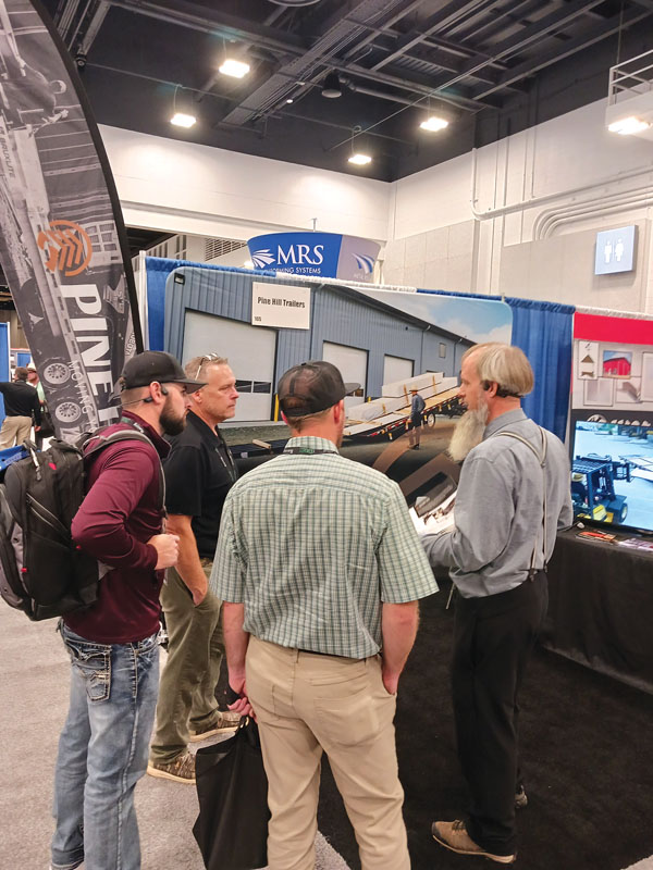 Conducting business in the Pine Hill Trailers booth at the Construction Rollforming Show. Shield Wall Media photo.